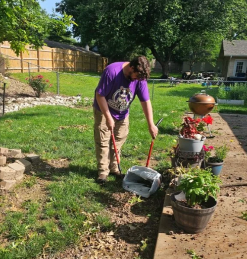 Eugene from Doggy Doods scooping a residential yard in St. Charles County on a sunny day.