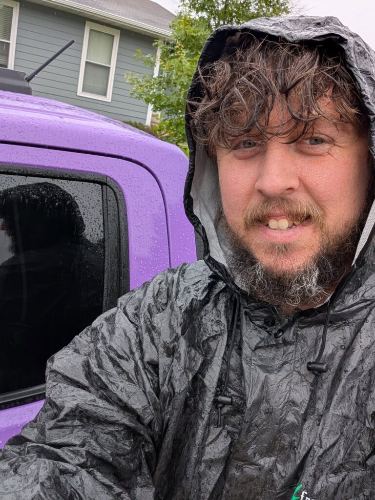Doggy Doods owner next to purple truck in the rain