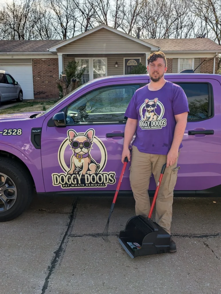 Doggy Doods owner standing next to the company's purple truck and pooper scooper equipment in St. Charles County, Missouri.